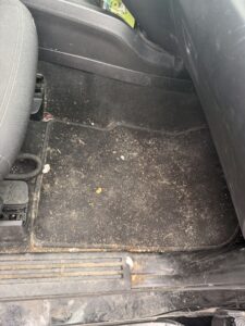 Before interior car detailing showing dirty cloth seats and carpet in Bath, Maine